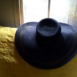 One black Angela and William sun hat and a white and black striped sun hat